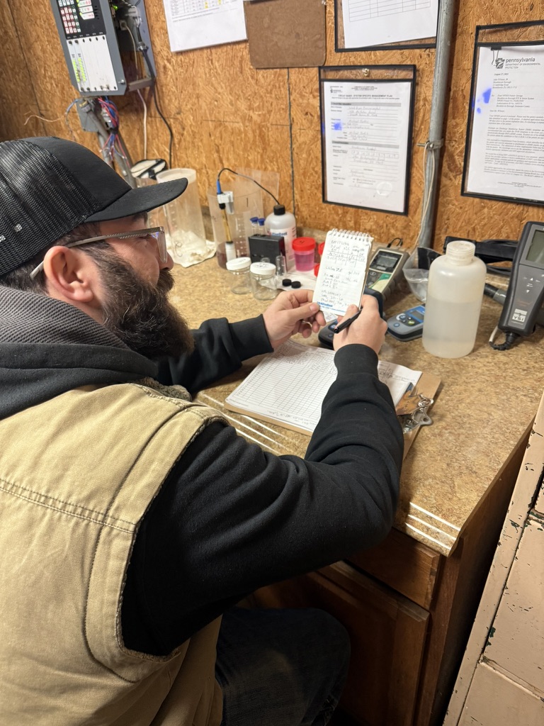 Operator reviewing readings and recording facility information